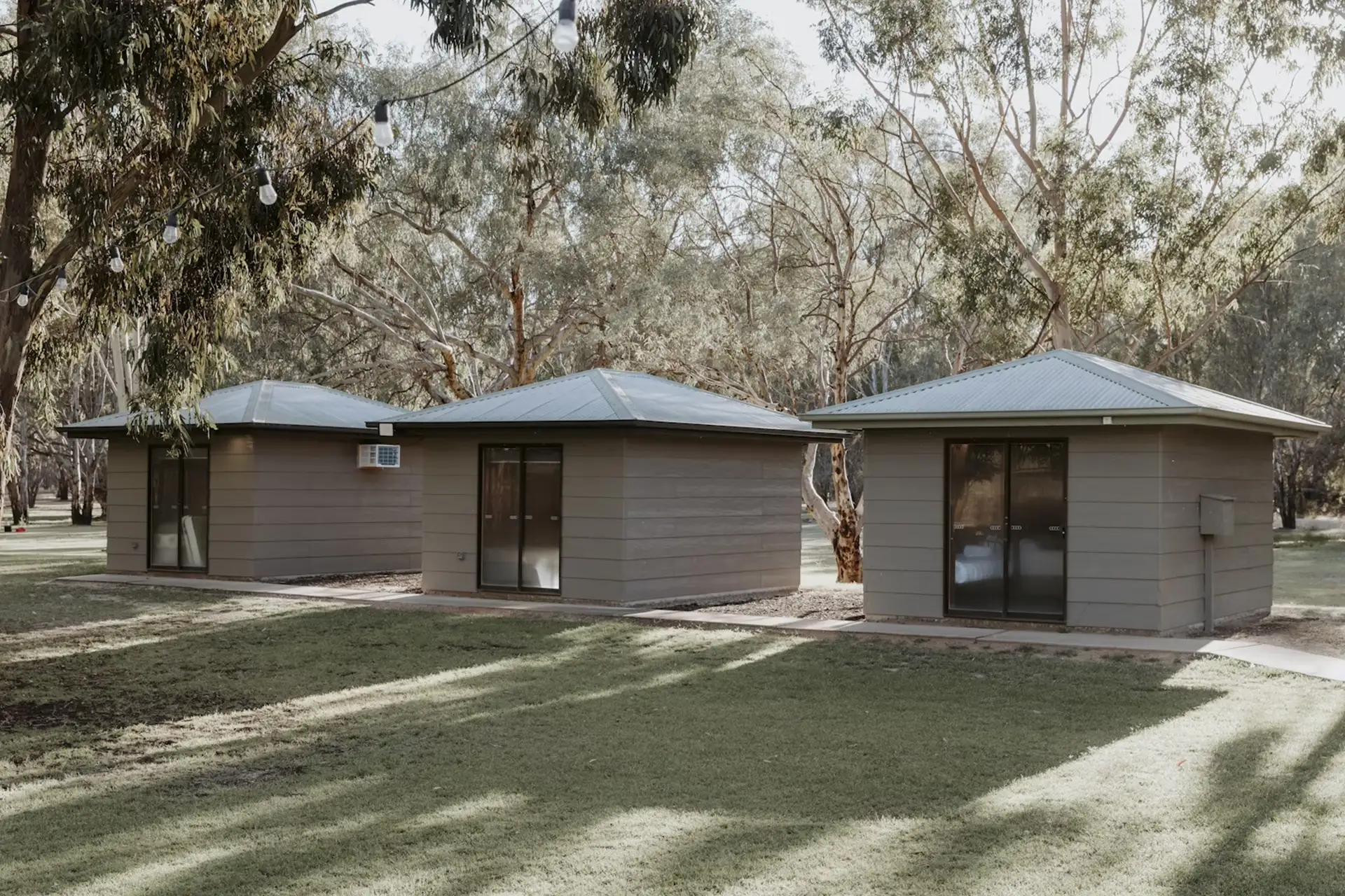 Self-contained cabins opening onto the lawns at The Paddock